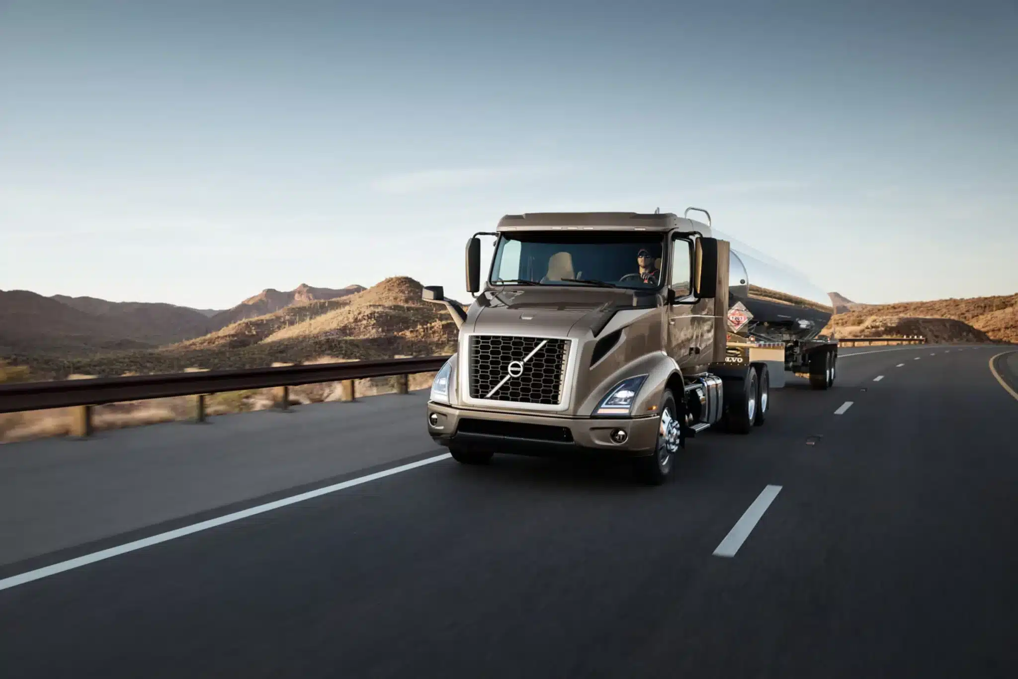 Volvo VNR 400 pulling a tank trailer on the freeway