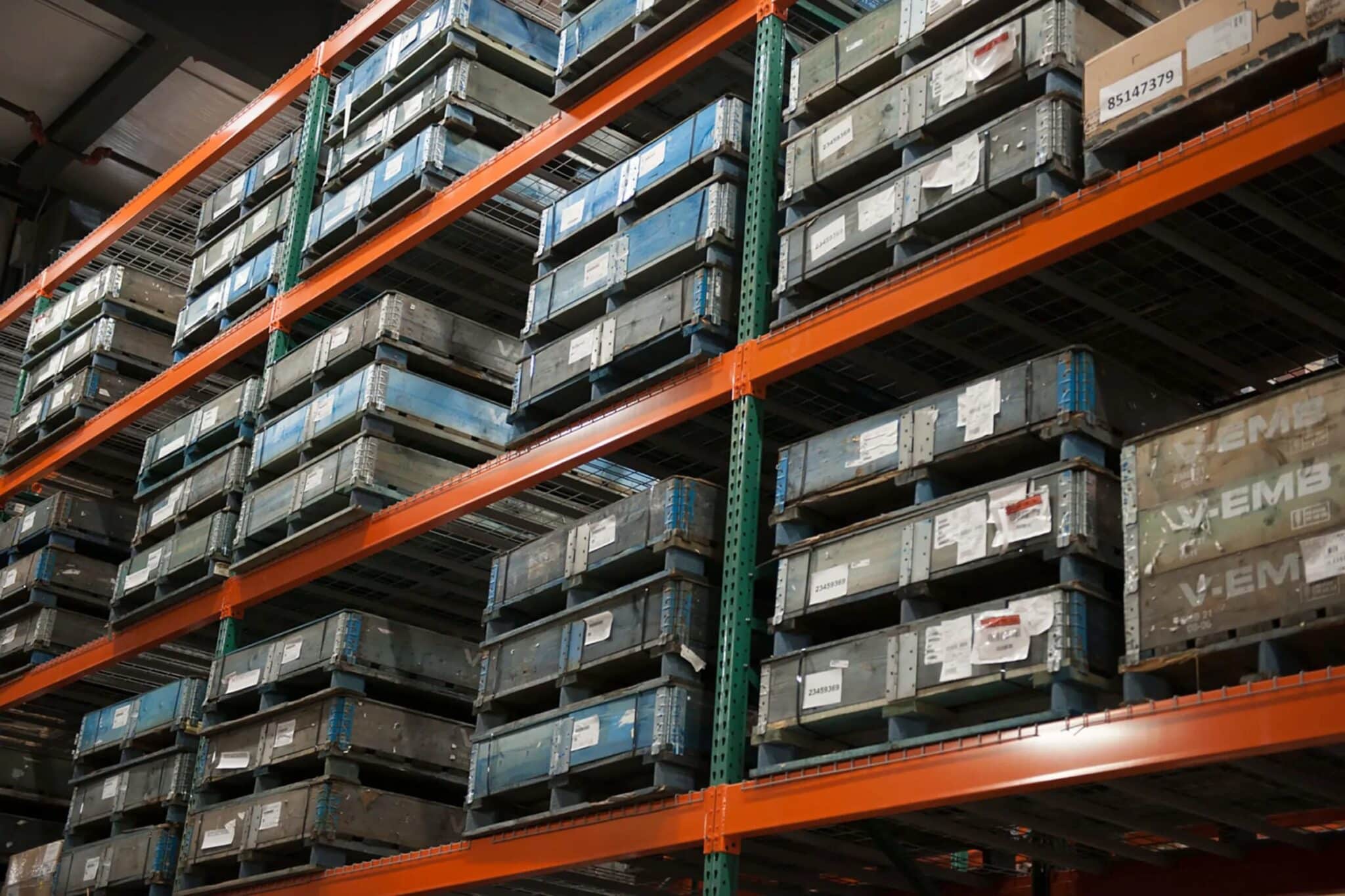 Pallets sitting on shelving in a parts warehouse.
