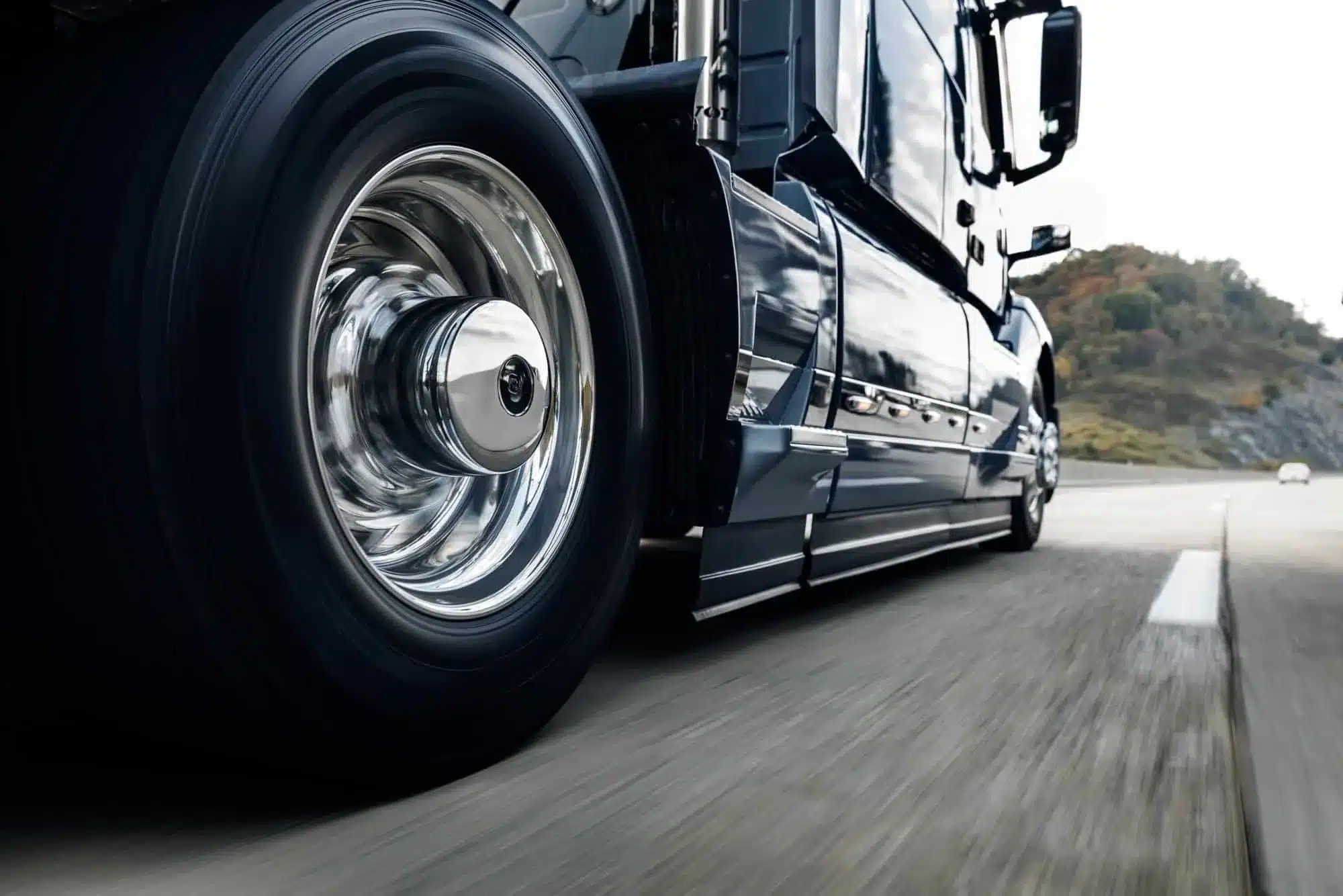 Close up of a Volvo VNL 400 wheels while driving on a road