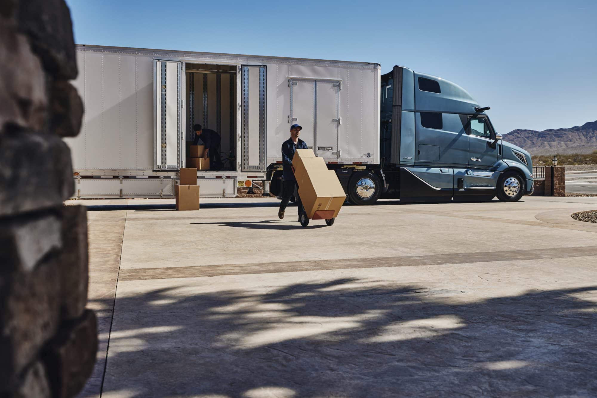 Worker taking boxes out of an all-new volvo vnl 860