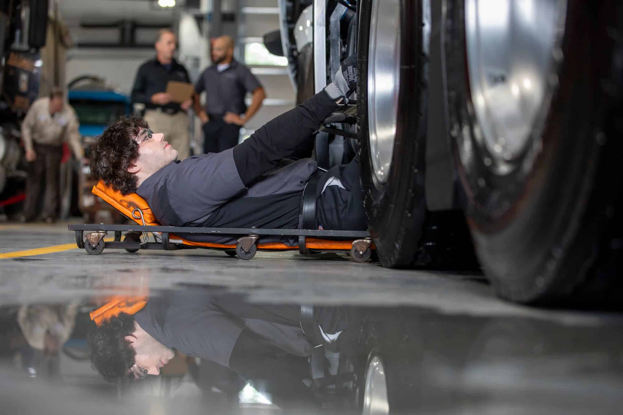 Service Technician at Wheel with Reflection