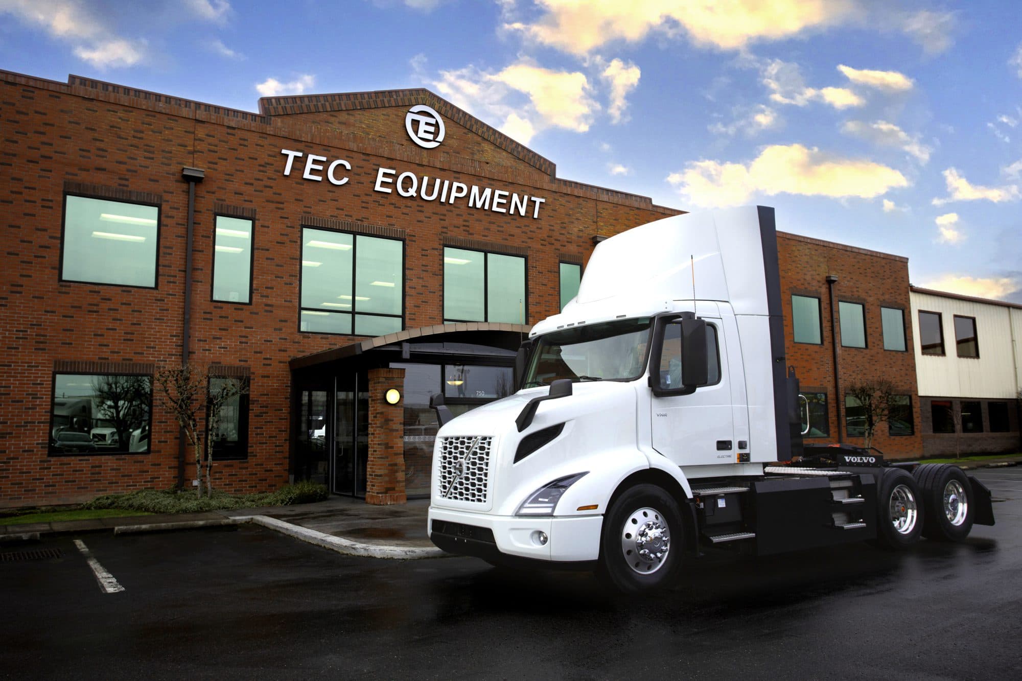 Volvo VNR Electric in front of a Mack and Volvo Trucks Certified EV Dealership