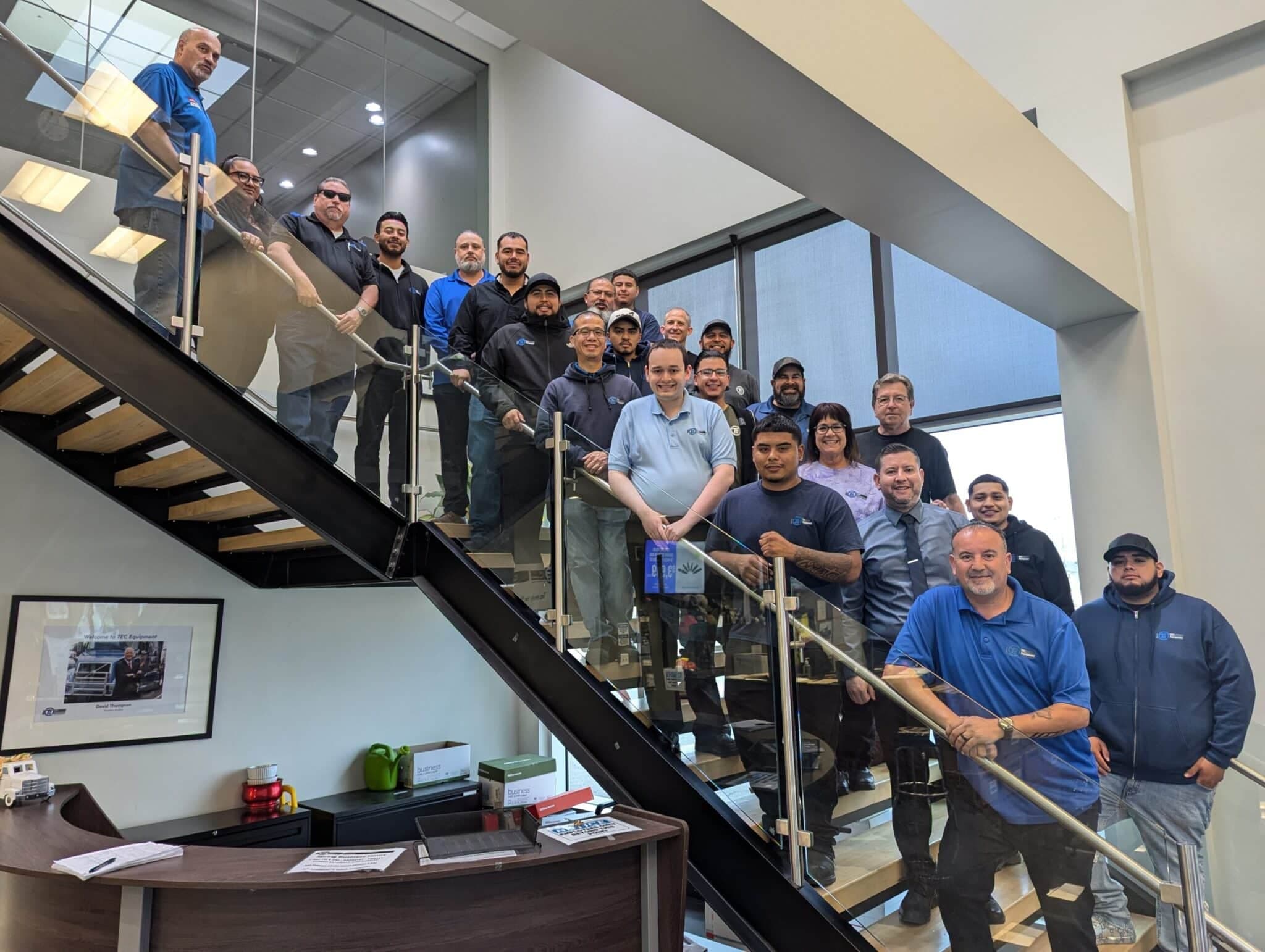 TEC Equipment - Oakland Parts team all lined up on the staircase in Oakland.